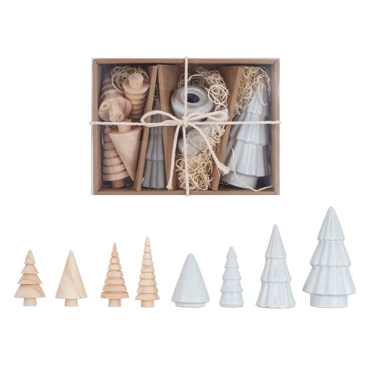 a box filled with different types of wooden christmas trees in it's display case