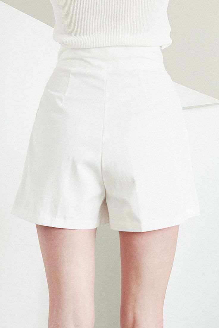 Grace Pintucked Shorts Front button and zip fly closure Front pintuck detail Short length Front functional pocket * Product Specification 100% Cotton * Flat Measurement: S/M: Waist: 31cm (12.2in) / Hip: 44cm (17.3in) / Thigh: 30cm (11.8in) / Rise: 32cm (12.6in) / Hem: 32.5cm (12.8in) / Length: 39.5cm (15.6in) / * Professional Clean Only / Do Not Tumble Dry Model's height is 5′ 6″ (173cm) Bust 32in Waist 24in Hip 36in and wearing S/M 사이즈 정보Size information (단위:cm)(Unit : inch) SXS/S 사이즈 정보 Size i White Bottoms With Built-in Shorts For Work, White Short Bottoms With Belt Loops, White Short Length Bottoms With Belt Loops, High-waisted Solid Color Shorts For Work, High-waisted Shorts For Work, White Shorts With Belt Loops, Solid Color Summer Workwear Shorts, Solid Color Workwear Shorts For Summer, Chic Solid Color Short Bottoms