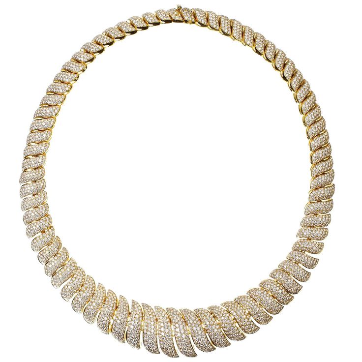 Diamond wave motif necklace evoking gentle waves of the surf. This stunning 18k gold necklace is set with over 30 carats of ideal cut round brilliant diamonds. These high quality diamonds are all near colorless (DEF) and having a clarity of vvs (very clean). The unique craftsmanship of this necklace allows for a gentle flexibility of the individual sections thus showing off the sparkle of these diamonds to their full beauty. Viewings available in our NYC wholesale office by appointment. Luxury Yellow Gold Diamond Necklace With Diamond Eyes, Luxury Gia Certified Round Cut Necklace, Luxury Gold Diamond Necklace With Round Stone, Luxury Spiral Diamond Jewelry, Luxury Custom Yellow Gold Diamond Necklace, Luxury Yellow Gold Diamond Custom Necklace, Jewelry Promotion, Flawless Diamond, Expensive Jewelry Luxury