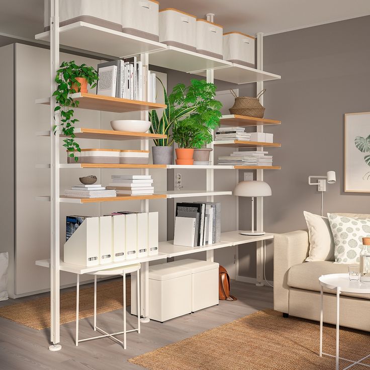 a living room filled with furniture and bookshelves next to a white couch in front of a window