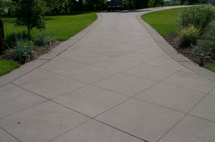 a paved walkway in the middle of a park