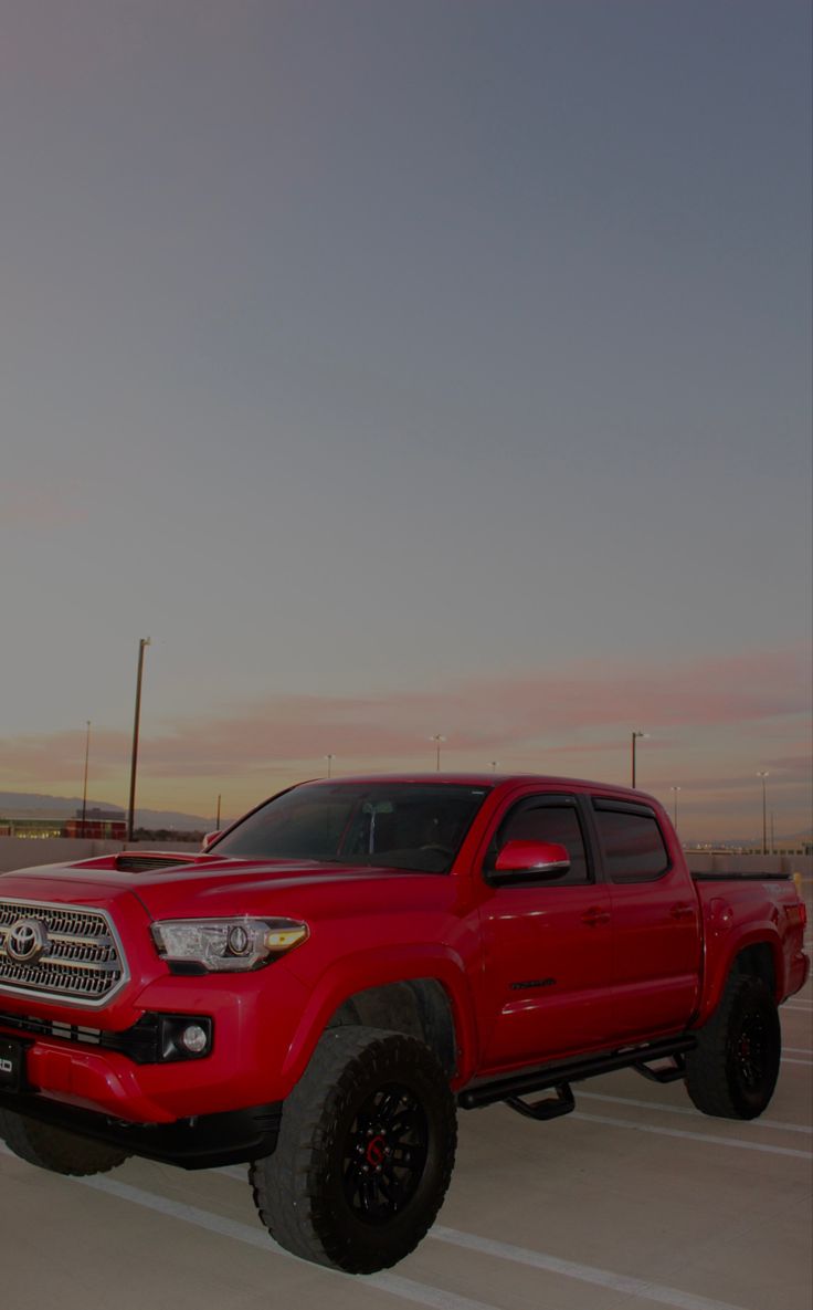 a red truck parked in a parking lot