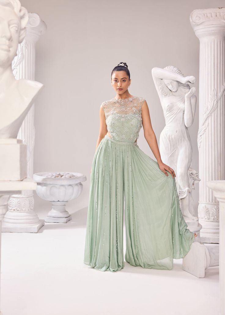 Upgrade your wardrobe with our stunning collection of ethereal couture outfits. The caroline jumpsuit is made with the finest fabrics and crafted with intricate pearl details. This ensemble comprises of a finelly hand embroidered Jacket and a Jumpsuit with a corset further highlighted with alternate kali detailing. Colour: Green Oasis Material: Net- Jacket, Shantley Net- bodice, Opara- kali (jumpsuit), Chinon- kali (jumpsuit) No of components: 2 Surface Ornamentation: Hand Embroidery Care Instructions: Dry Clean Shipping Time: 3-4 weeks Net Jacket, Surface Ornamentation, Green Oasis, Shirt Jacket Men, Drape Saree, Pearl Details, Couture Outfits, Silk Roses, Embroidered Jacket