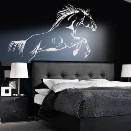 a black and white bedroom with a horse decal on the wall