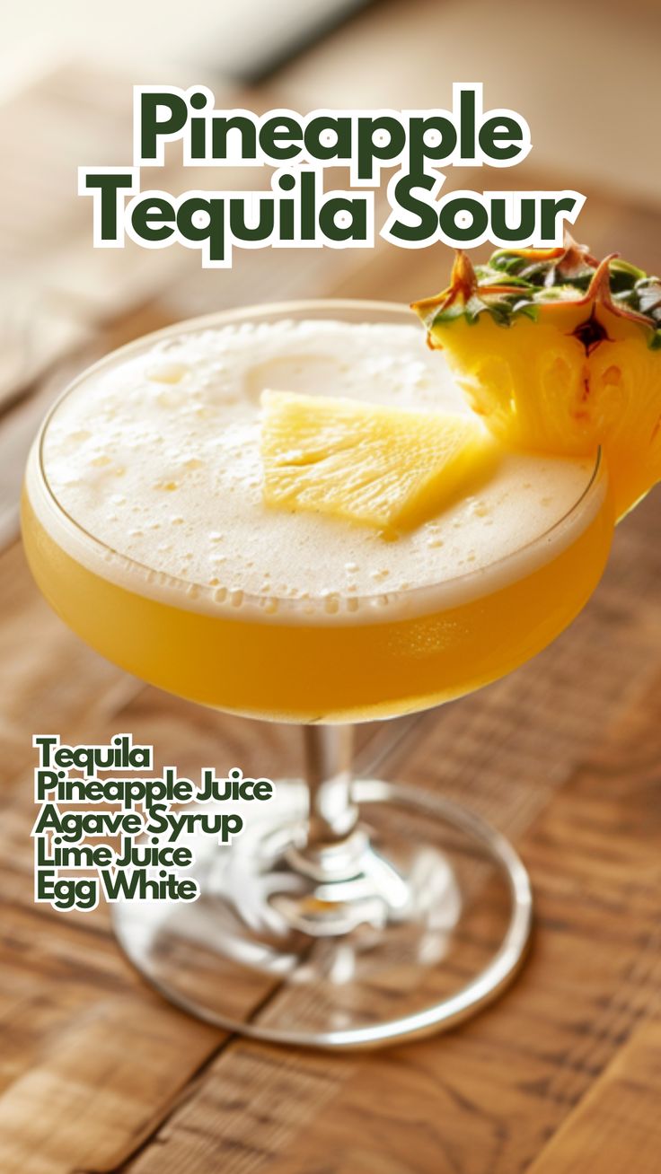 the pineapple tequila sour cocktail is garnished with an orange slice