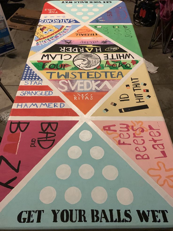 a long table covered in lots of different types of stickers on it's sides