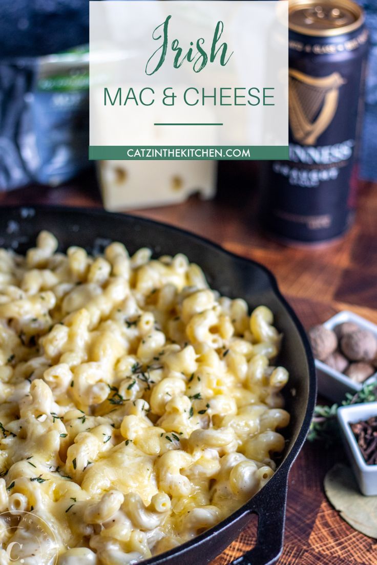 a skillet filled with macaroni and cheese on top of a wooden table