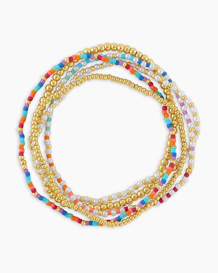 Mentally, you're on vacation. Channel a beachside getaway in this set of six pearl bracelets. Stacked together or worn separately, this bracelet set gives you a variety of fun styling options. Product Details Set of 5 mismatched elastic bracelets 6 3/4" interior diameter Mix of 1/16" rainbow and pearlized beads Gold beads measure 1/16" and 1/8" Available in 18k gold plated brass Avoid contact with anything containing derivatives of alcohol Bead color and pattern may vary slightly | Poppy Bracele Pearl Seed Bead Bracelet, Gold Jewelry Summer, Enewton Bracelets Stacks, E Newton Bracelets, Enewton Bracelet, Every Jewels, Small Beaded Bracelets, Cute Gold Jewelry, Summer Beaded Bracelets