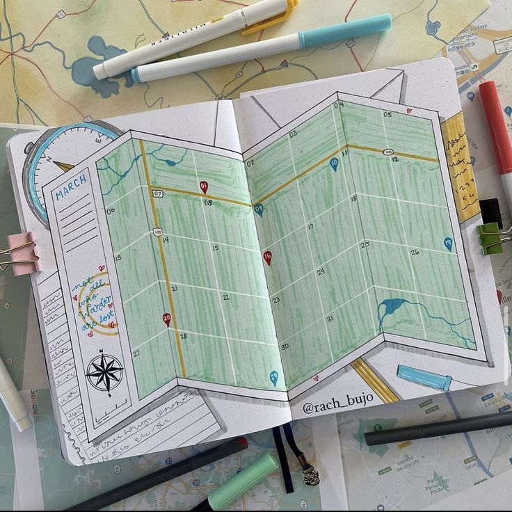 an open book with maps and markers on it