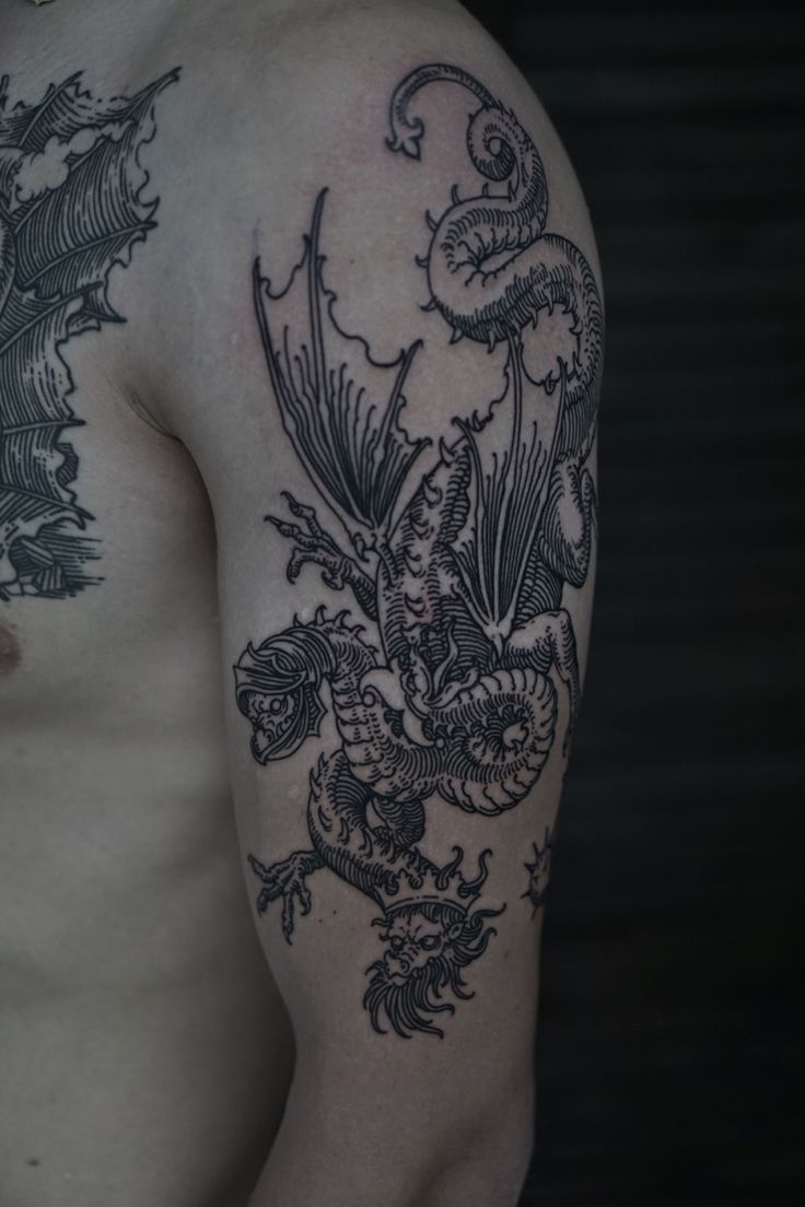 a man with a dragon tattoo on his arm