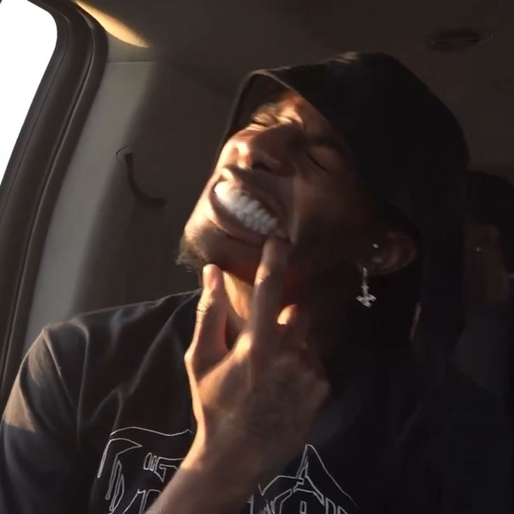 a man sitting in the back seat of a car laughing