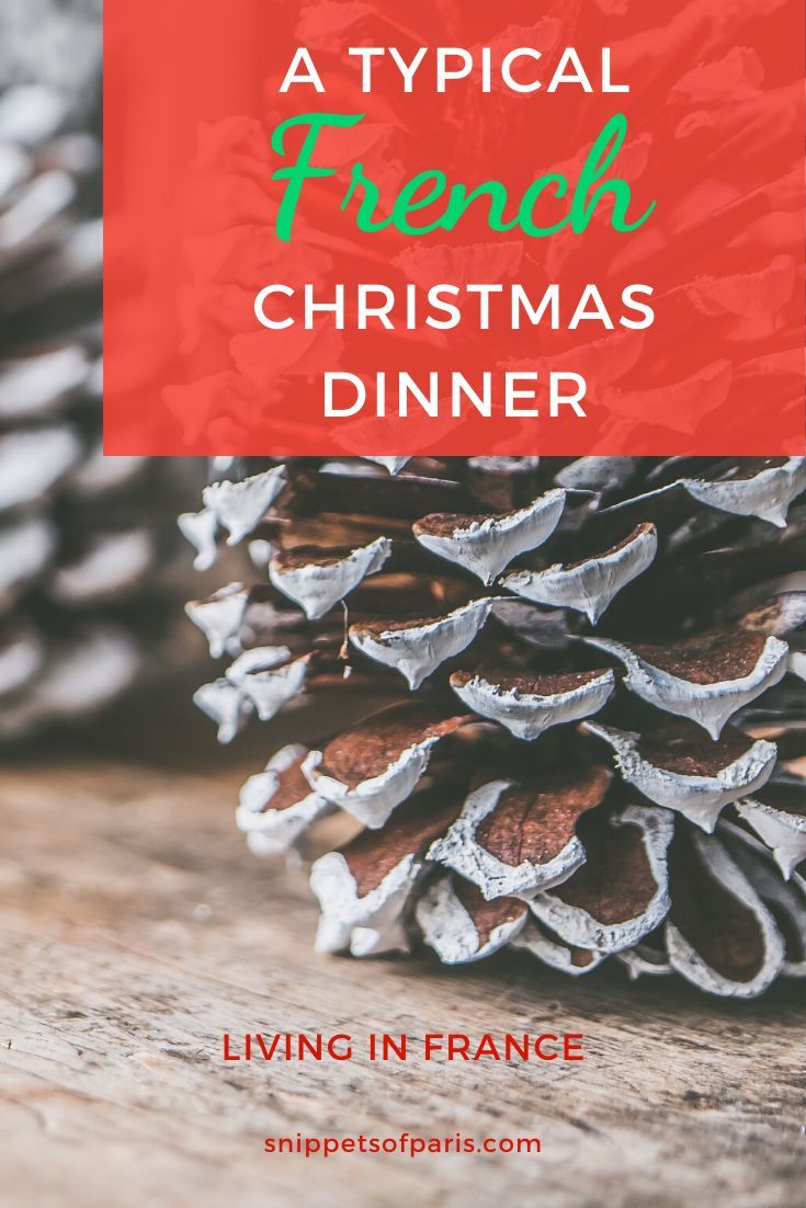 a pine cone sitting on top of a wooden table with text overlay that reads, a typical french christmas dinner living in france