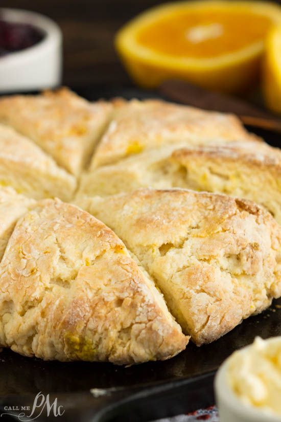 a close up of a pastry on a pan with oranges in the back ground