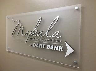 a glass sign that says mydala motor detailing dart bank on the side of a wall