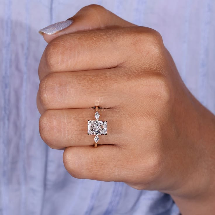 a woman's hand with a diamond ring on it