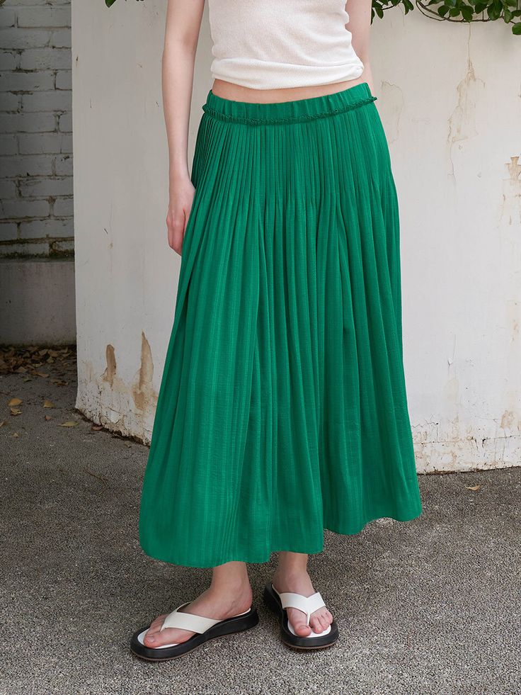 Editor's NoteThis is a long skirt with mechanical pleats from the waist and a straight, falling silhouette that stands out for its slenderness.- Banded at the waist for a comfortable fit- It is composed of colors that are good to wear in summer, so you can coordinate coolly- Lined for stable wear- Available in 2 colors: White, GreenMeasurements (in.)55 / 66- Length: 33.86 in. / 34.65 in.- Waist circumference: 25.98 in. / 27.95 in.Composition & Care- Shell: 65% Rayon, 35% Polyester   Color fabric: 100% Polyester   Lining: 100% Polyester- Please check the care labelDesigner- by OLIVE DES OLIVE Wide Leg Pleated Skirt With Elastic Waistband For Spring, Casual Spring Skirt With Folds, High-waisted Pleated Work Skirt, Green Pleated Bottoms For Spring, Summer Midi Skirt With Folds, Long Pleated Skirt With Elastic Waistband, Spring Green Pleated Bottoms, Long Pleated Skirt With Elastic Waistband And Voluminous Fit, Spring Voluminous Pleated Skirt With Elastic Waistband