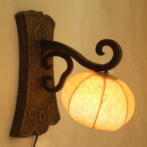 a light that is on the wall with a lamp attached to it's side