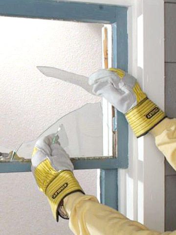 a person wearing gloves and holding a window sealer