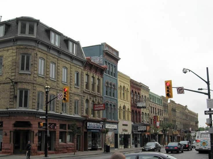 a city street filled with lots of tall buildings and traffic lights next to each other