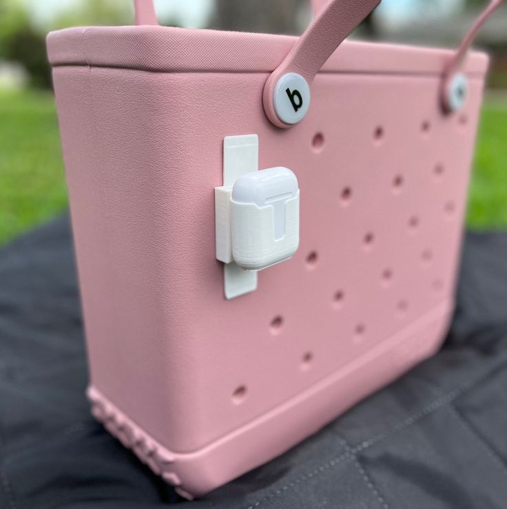 a pink handbag sitting on top of a black table