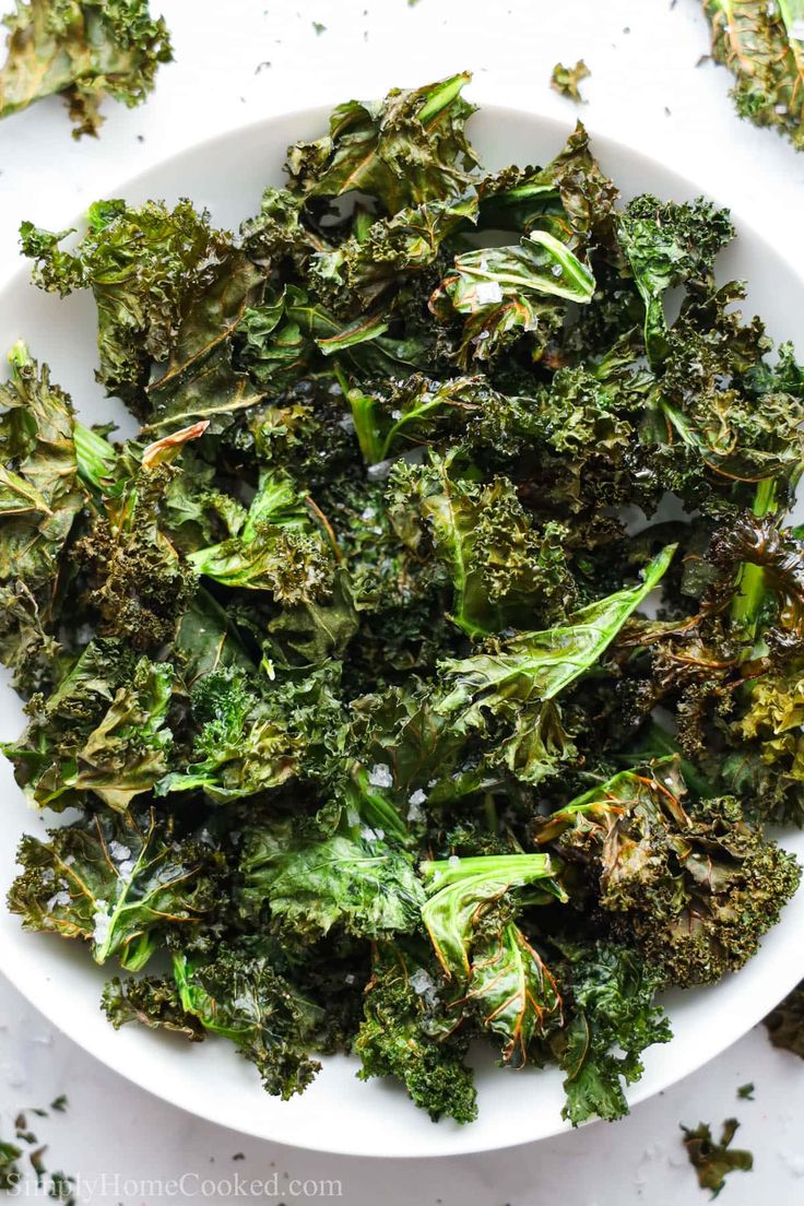 a white bowl filled with broccoli florets on top of a table