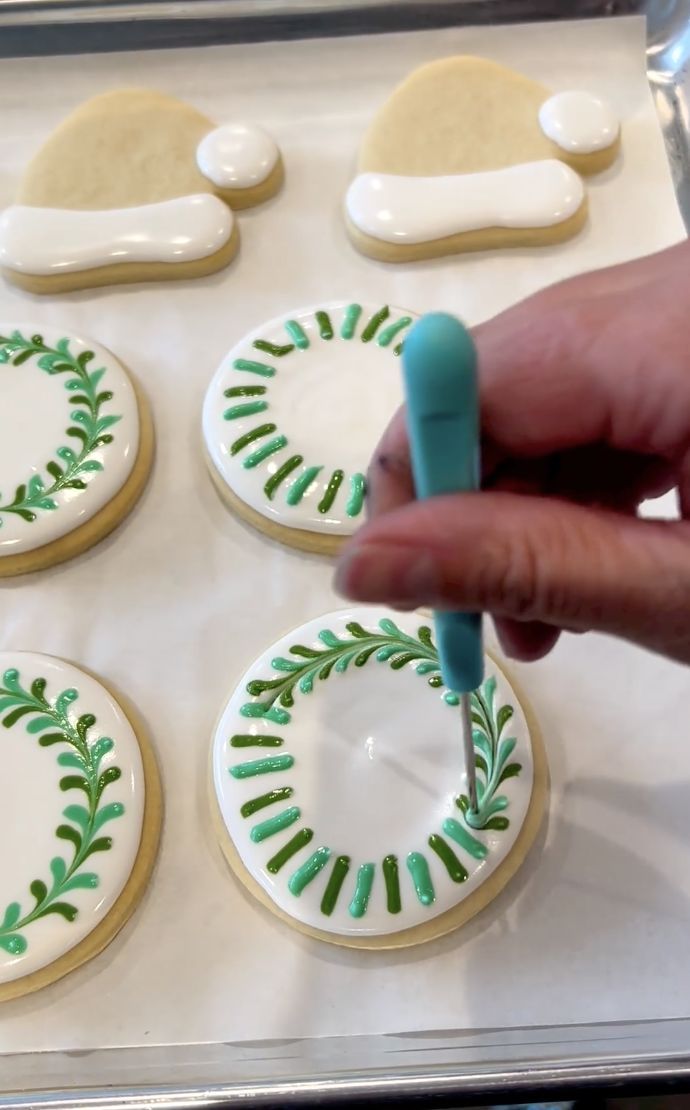 someone is decorating decorated cookies with icing