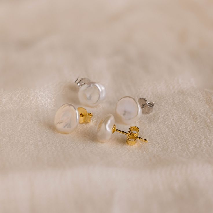 Exquisite in simplicity, our Freshwater Pearl Studs add a touch of refined charm to any occasion. Ideal for formal events or as a heartfelt Mother's Day surprise, these pearl earrings exude timeless elegance for every moment 🤍✨ SKU: RR-ER472 Product Details Material: High Quality Solid 925 Sterling Silver Finish: 18K Gold ∙ Sterling Silver Featuring Freshwater Pearl Stud Earrings, Pearls ranging from ~9-11mm Sold as a Pair Featured Styles Part of our Pearl Collection Model showcases an elegant, Timeless Round Pearl Earrings For Everyday, Minimalist Round Pearl White Earrings, Elegant Pearl White Everyday Earrings, Elegant Everyday Pearl White Earrings, Elegant Everyday Pearl White Pearl Earrings, Classic Pearl White Jewelry With Pearl Buttons, Refined Round Pearl Earrings As Gift, Refined Round Pearl Earrings For Gift, Formal Minimalist Pearl Earrings With Charm