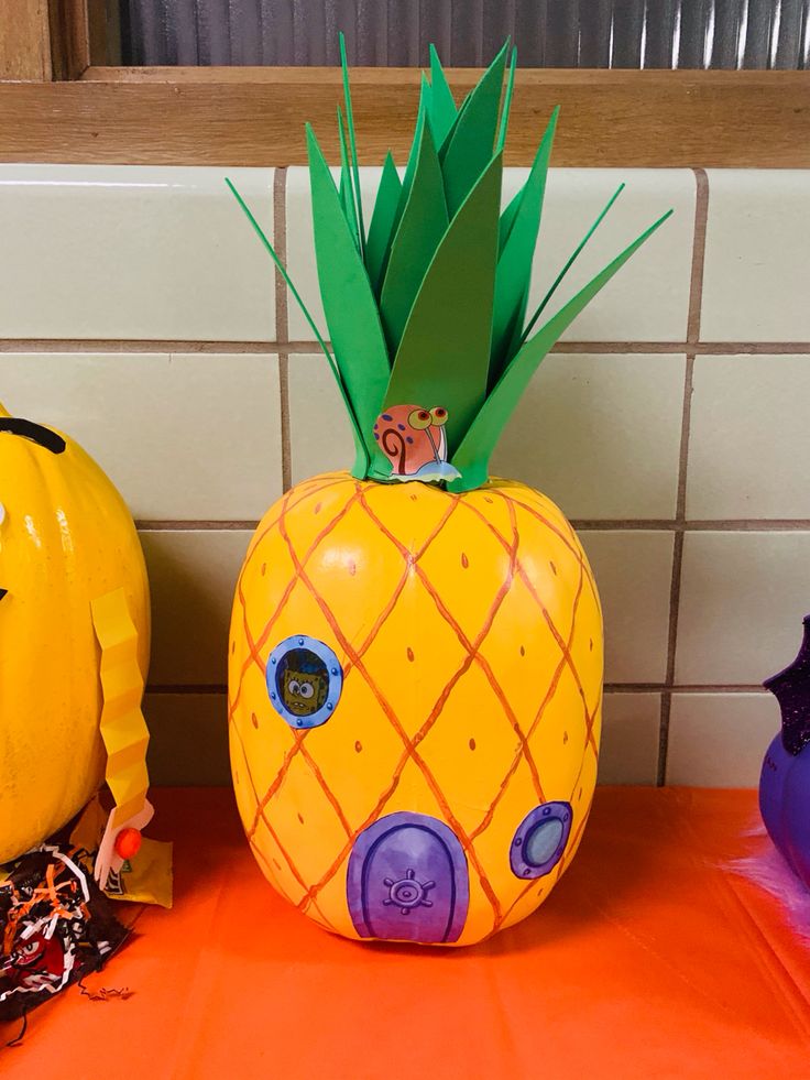 two plastic pumpkins sitting next to each other on a table