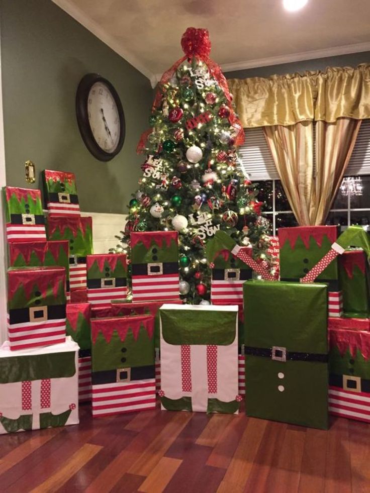 a christmas tree is surrounded by presents on the floor