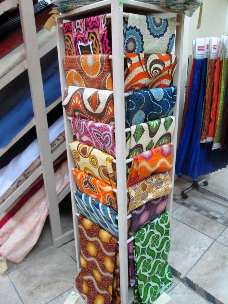 a rack that has many different colored ties on it