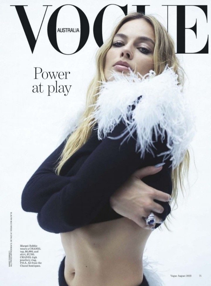 a woman in black top and white feathers on the cover of magazine voiee