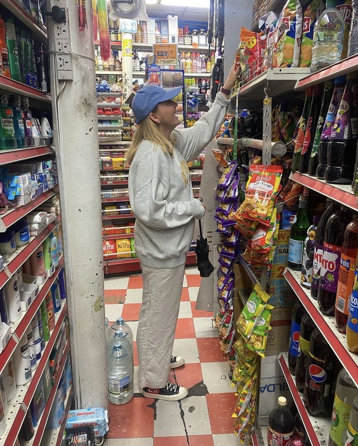 a woman is shopping in a grocery store