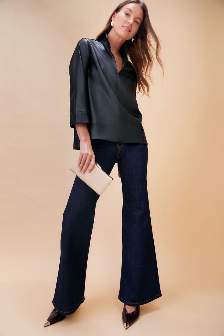 The Margot Blouse is one of our favorite silhouettes, and is now updated in a soft faux leather for a chic look. The sleek stand collar creates a classic, sophisticated look but also pairs well with denim for a more casual vibe. We are wearing this top from meetings to date night with a quick change of accessories! Stand collar V-neckline Three-quarter length sleeves Slits at back of elbows Faux leather Material: 55% Synthetic, 45% Polyester Care: Hand wash cold extra gentle, hang to dry Accessories Stand, Cocktail Attire, Whale Tail, Fly High, Weekend Wear, Night Looks, Fashion House, Flared Jeans, Office Fashion