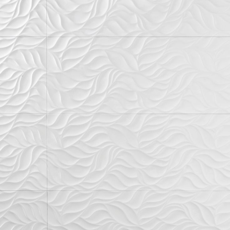 a white tile wall with wavy lines on it