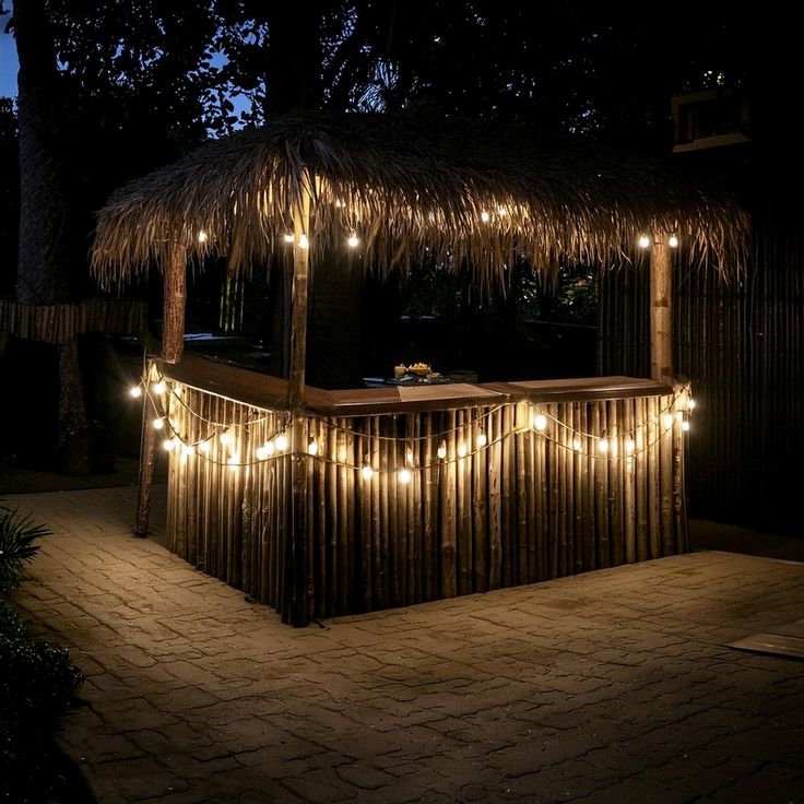 a tiki bar covered in lights at night