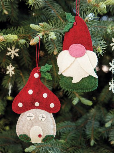 two christmas ornaments hanging from a tree