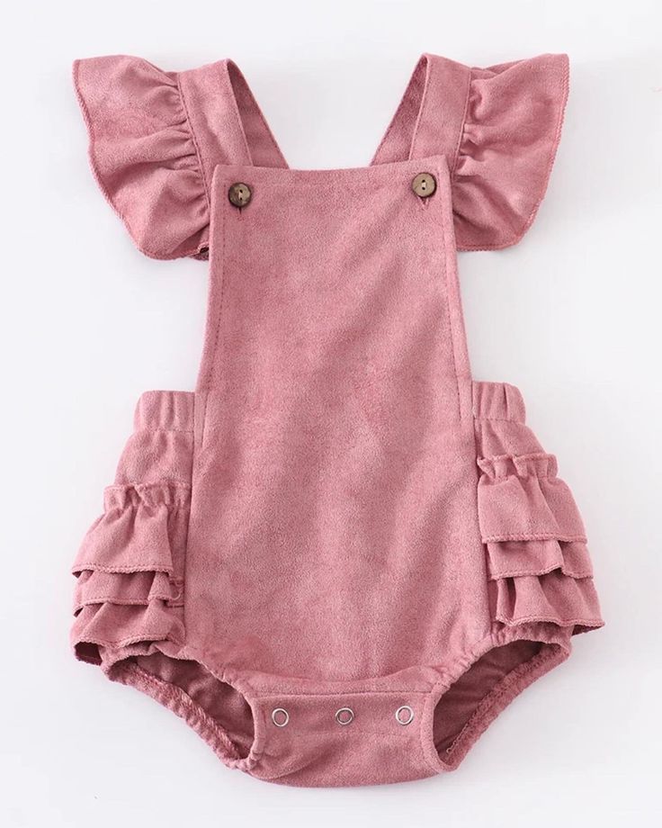 Suede is in this spring and this ruffled romper is stunningly precious.  Layer this beautiful style with a long-sleeved top or romper and tights.  This style coordinates with our Suede Ruffled Jonjon.  Snap button closure for easy changes.   Machine Washable.  Hang or Lay Flat to Dry.  Color: Rose  Sizes:  3M, 6M, 12M and 18M. Spring Cute Bubble Romper With Ruffle Sleeves, Spring Cotton Bubble Romper With Ruffle Sleeves, Spring Casual Bodysuit With Ruffles, Spring Bubble Romper With Ruffles, Spring Bubble Romper With Ruffles And Flutter Sleeves, Cute Bubble Romper Overall For Spring, Cotton Bubble Romper With Ruffle Sleeves, Summer Long Sleeve Jumpsuits And Rompers With Ruffles, Chic Cotton Jumpsuits And Rompers With Ruffles