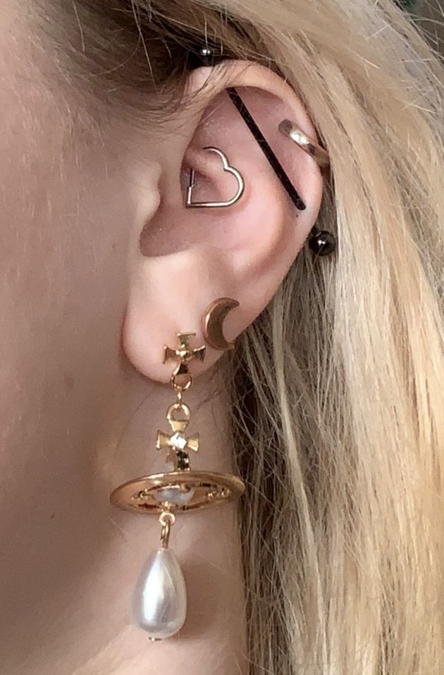 an ear with several piercings and earrings on it Aesthetic Daith Piercing, Daith And Industrial Piercing, Vivienne Westwood Earrings Gold, Vivienne Westwood Jewellery Aesthetic, Ear Design Piercing, Ear Piercing Designs, Ear Piercing Layout, Silver Ear Piercings, Industrial Piercing Aesthetic