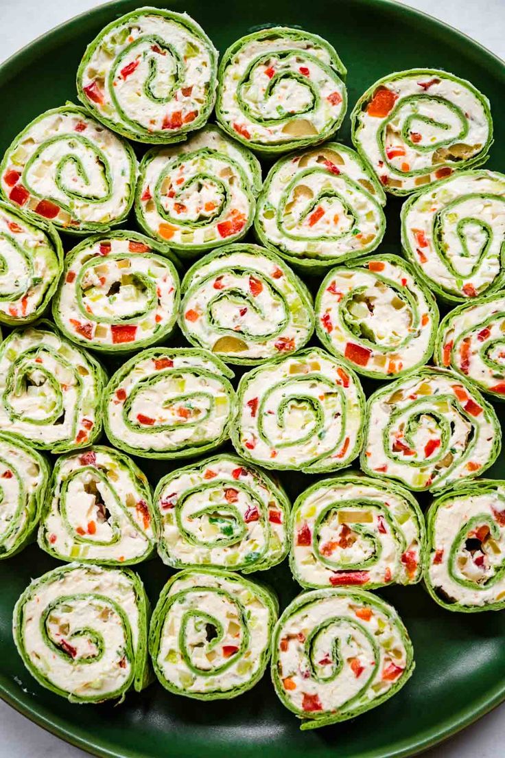 spinach rolls are arranged on a green plate and ready to be eaten for lunch