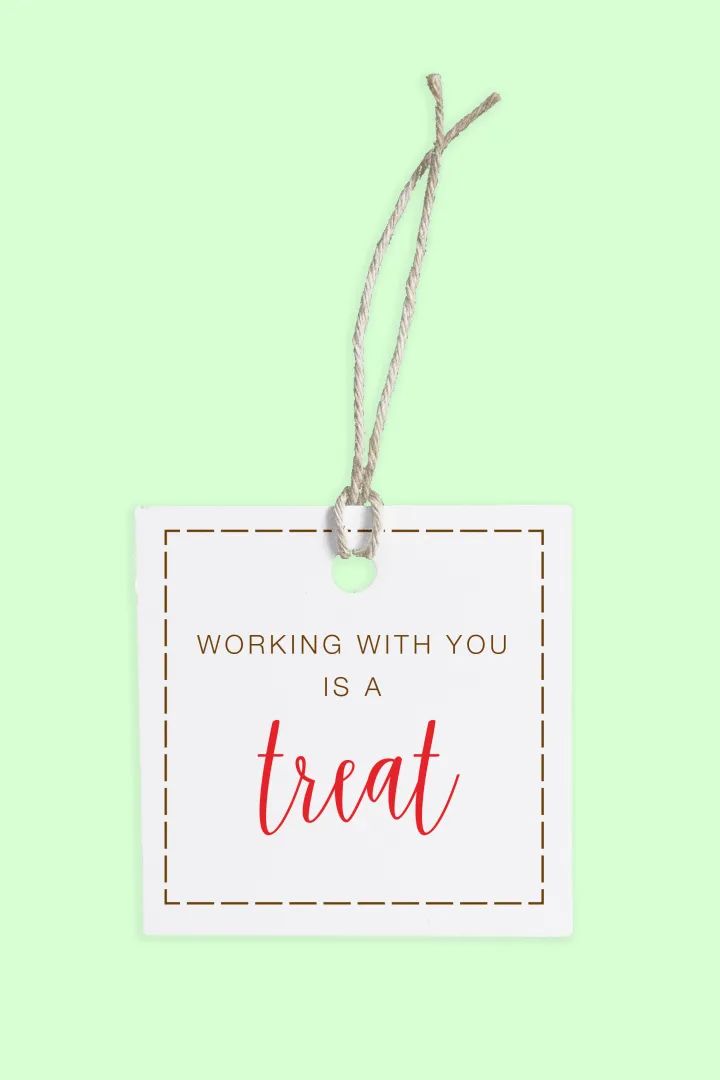 a white sign with the words working with you is a treat hanging from a string