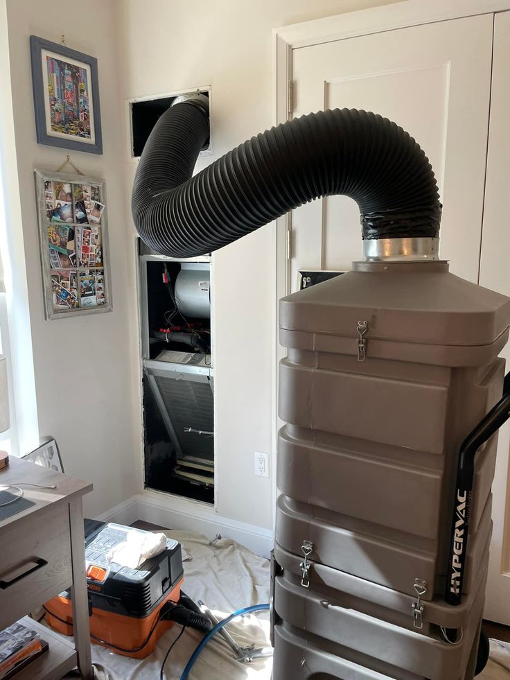 a large blow dryer sitting on top of a hard floor next to a window