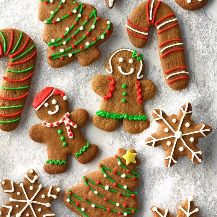 gingerbread cookies decorated with icing and candy canes on a sheet of paper