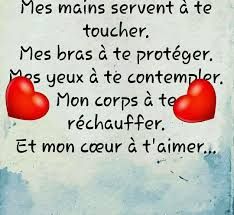 two red hearts sitting on top of a piece of paper with words written in french