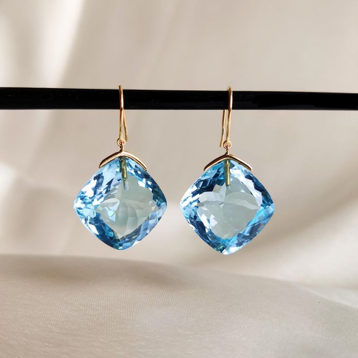 These stunning earrings are set in 14k Solid Yellow Gold with Natural Sky Blue Topaz with utmost precision. It is an unique gemstone earring pair for nearly every occasion and is completely hassle-free jewelry. 🔷 ABOUT GEMSTONE Sky Blue Topaz is a mesmerizing gemstone admired for its serene, clear blue hue, reminiscent of a cloudless sky. Known for its calming energy, Sky Blue Topaz is cherished for enhancing clarity of thought, communication, and self-expression. This stone is linked to the th Light Blue Gemstone Earrings - Fine Jewelry, Blue Briolette Earrings For Formal Occasions, Luxury Topaz Earrings For Formal Occasions, Elegant Blue Diamond Cut Earrings, Luxury Blue Topaz Drop Earrings, Elegant Light Blue Gemstone Earrings, Elegant Blue Topaz Briolette Earrings, Fine Jewelry Light Blue Earrings For Formal Occasions, Luxury Blue Briolette Earrings