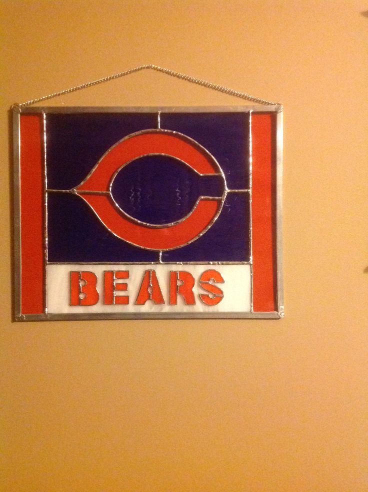 a chicago bears stained glass sign hangs on the wall