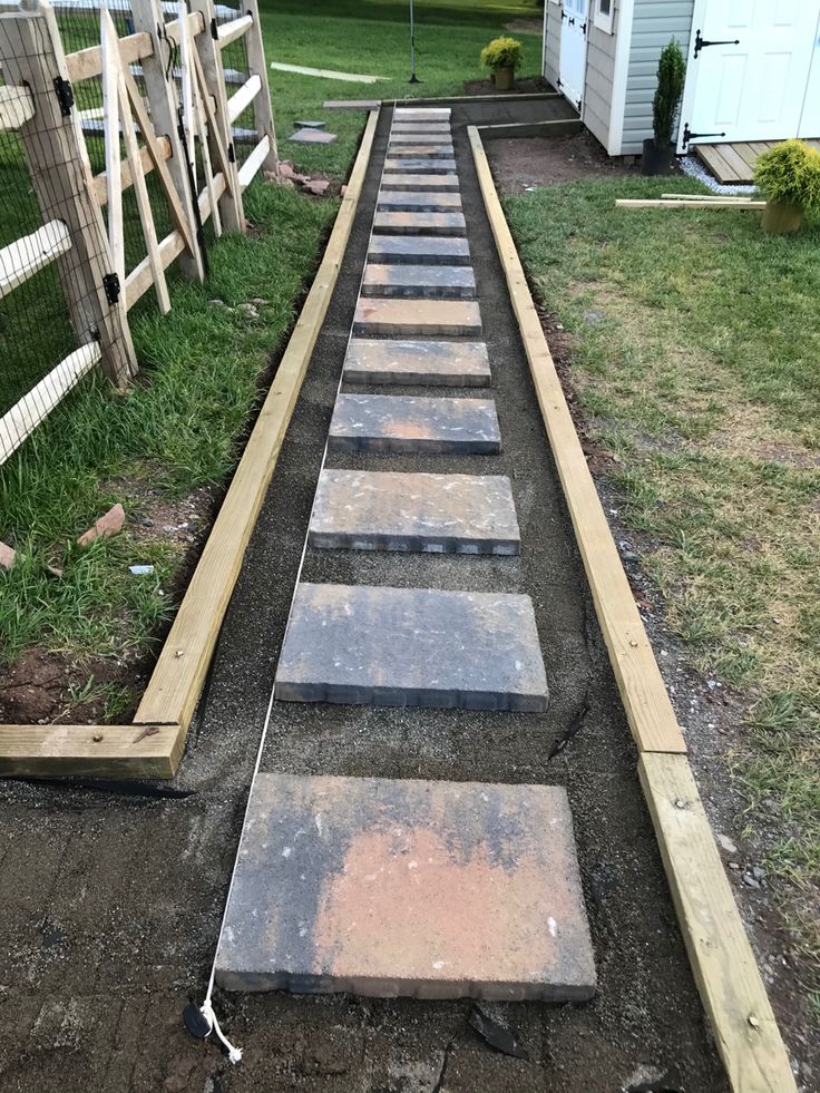 a set of steps leading up to a fenced in area with grass on the other side