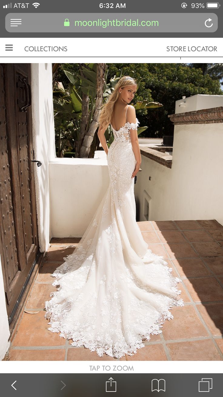 a woman in a white wedding dress standing on a balcony with her back to the camera