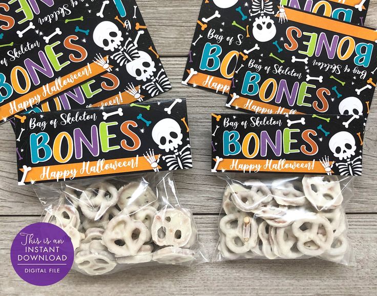 three bags of bones with happy halloween stickers on them