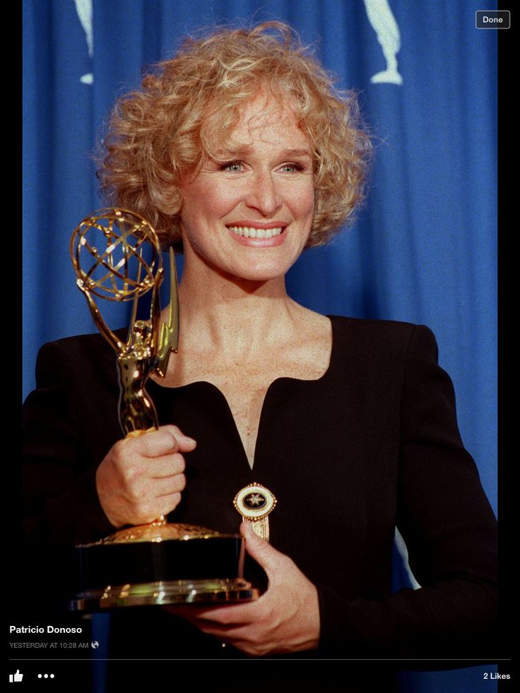 the actress poses with her award for outstanding performance