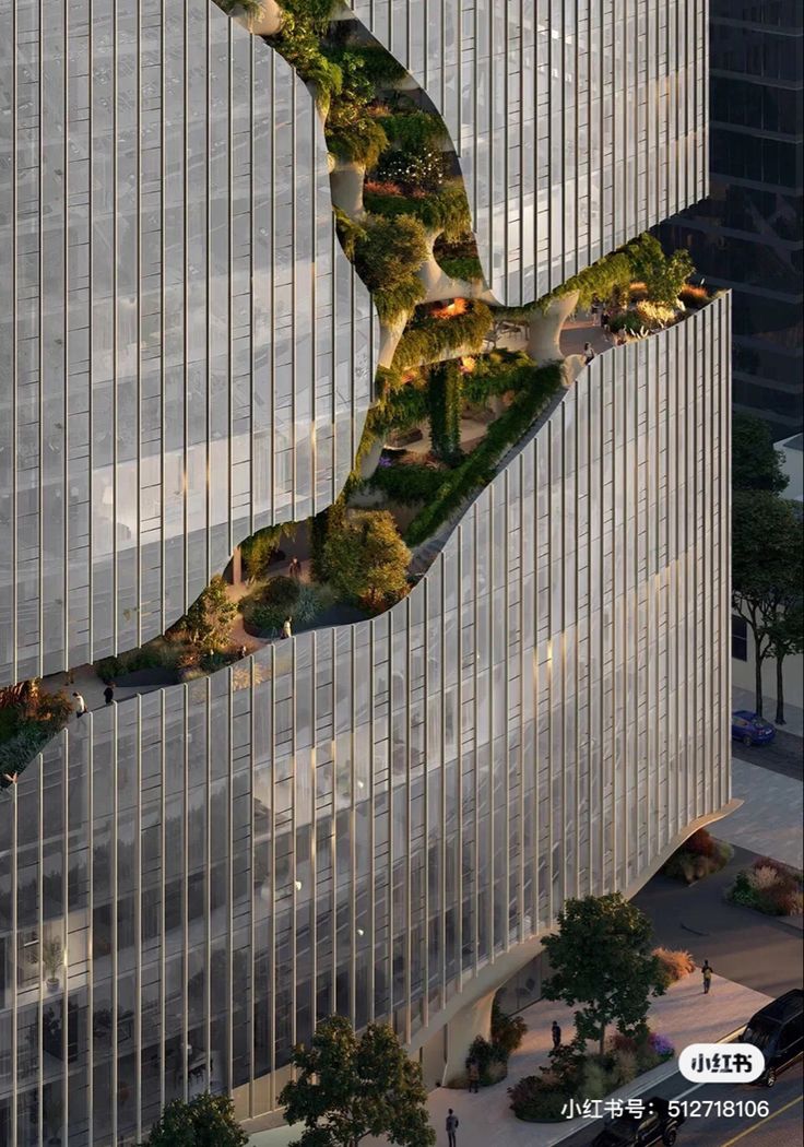 an aerial view of a curved building with trees on the side and cars driving down the street